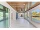 Sunroom with a wood ceiling, tile flooring, and lots of natural light from the windows at 502 69Th St, Holmes Beach, FL 34217