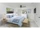 Serene main bedroom with a coastal aesthetic, featuring shiplap walls and soft blue accents at 502 69Th St, Holmes Beach, FL 34217