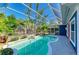 Enclosed pool area with clear blue water, lush landscaping, and a screened enclosure at 502 69Th St, Holmes Beach, FL 34217