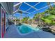 Screened pool with tropical landscaping and a water feature is perfect for relaxing and entertaining at 502 69Th St, Holmes Beach, FL 34217