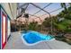 Beautiful pool area at sunset surrounded by lush landscaping and a screened-in enclosure at 502 69Th St, Holmes Beach, FL 34217