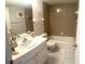 Cozy bathroom with a bathtub, tile walls, and a vanity with sink at 507 Parkdale Mews # 507, Venice, FL 34285