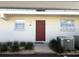 Exterior of condo featuring covered parking, a red door, and minimal landscaping at 507 Parkdale Mews # 507, Venice, FL 34285