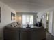 Spacious living room with wood floors, comfortable sectional sofa, and sliding glass doors at 507 Parkdale Mews # 507, Venice, FL 34285