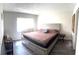 Comfortable main bedroom with wood floors, large bed, and plenty of natural light at 507 Parkdale Mews # 507, Venice, FL 34285