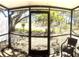 Screened patio with a view of a green space and mature landscaping at 507 Parkdale Mews # 507, Venice, FL 34285
