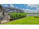 Beautiful backyard with lush green lawn and a view of the lake at 5562 Rain Lily Ct, Sarasota, FL 34238
