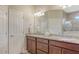 Bathroom with double sinks, granite countertop, and large mirror at 5562 Rain Lily Ct, Sarasota, FL 34238
