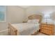 Comfortable bedroom featuring a wooden bed frame, two side tables, and a window with natural light at 5562 Rain Lily Ct, Sarasota, FL 34238