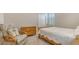 Inviting bedroom with a chair, dresser, and wooden bed frame, creating a relaxing space at 5562 Rain Lily Ct, Sarasota, FL 34238