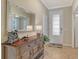 Well-lit foyer featuring tile flooring, a decorative mirror, and an elegant glass-paneled front door at 5562 Rain Lily Ct, Sarasota, FL 34238