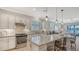 Bright kitchen with stainless appliances and island with seating at 5562 Rain Lily Ct, Sarasota, FL 34238