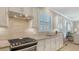 Well-lit kitchen with stainless steel appliances, granite countertops and bright window at 5562 Rain Lily Ct, Sarasota, FL 34238