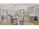 Bright kitchen with stainless appliances and island with seating at 5562 Rain Lily Ct, Sarasota, FL 34238