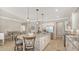 Spacious kitchen with granite island, stainless steel appliances, and open layout to the dining room at 5562 Rain Lily Ct, Sarasota, FL 34238
