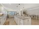 Open-concept kitchen with island, stainless steel appliances, and views of the living and dining areas at 5562 Rain Lily Ct, Sarasota, FL 34238