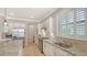 Bright kitchen featuring stainless steel appliances, granite countertops, backsplash, and shuttered window at 5562 Rain Lily Ct, Sarasota, FL 34238