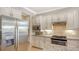 Well-lit kitchen with stainless appliances, tile backsplash and spacious cabinetry at 5562 Rain Lily Ct, Sarasota, FL 34238