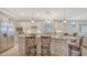 Bright kitchen with stainless appliances and island with seating at 5562 Rain Lily Ct, Sarasota, FL 34238
