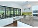 Modern kitchenette with a large island, stainless steel appliances and sleek design at 5562 Rain Lily Ct, Sarasota, FL 34238