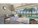 Covered lanai with built in grill and view of pool and lake at 5562 Rain Lily Ct, Sarasota, FL 34238