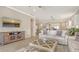 Open concept living room with view into kitchen and breakfast bar at 5562 Rain Lily Ct, Sarasota, FL 34238