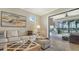 Living room showcasing decor and view of covered outdoor grill area at 5562 Rain Lily Ct, Sarasota, FL 34238