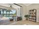 Living room with view of the screened lanai, pool and lake at 5562 Rain Lily Ct, Sarasota, FL 34238