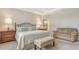 Comfortable main bedroom with sitting area, access to ensuite bathroom, and elegant decor at 5562 Rain Lily Ct, Sarasota, FL 34238