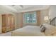Bright main bedroom with ceiling fan, plantation shutters and elegant furnishings at 5562 Rain Lily Ct, Sarasota, FL 34238