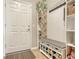 Well-organized mudroom with a shoe rack bench, coat hooks, and shelving for storage at 5562 Rain Lily Ct, Sarasota, FL 34238
