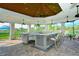 Spacious outdoor kitchen with granite countertops, bar seating, and ceiling fans for comfort at 5562 Rain Lily Ct, Sarasota, FL 34238