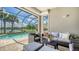 Relax on the beautiful screened in patio with an outdoor seating area and lovely view of the pool and waterfront at 5562 Rain Lily Ct, Sarasota, FL 34238