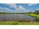 Scenic view of the community pond, showcasing the tranquil waters and lush surroundings at 5562 Rain Lily Ct, Sarasota, FL 34238