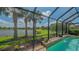 Relax by the pool with beautiful view of the lake, all protected by the screened-in lanai at 5562 Rain Lily Ct, Sarasota, FL 34238