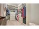 Organized walk-in closet with shelving, drawers, and hanging space for a variety of clothing and accessories at 5562 Rain Lily Ct, Sarasota, FL 34238