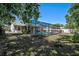 Spacious backyard featuring a sparkling pool with a screened enclosure and lush landscaping at 5611 22Nd E St, Bradenton, FL 34203