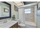 Well-lit bathroom featuring a vanity, tub, and shower at 5611 22Nd E St, Bradenton, FL 34203