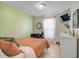 Cozy bedroom with an accent wall, desk, and natural light at 5611 22Nd E St, Bradenton, FL 34203