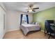 Bright bedroom with a large window, accent wall, and a ceiling fan at 5611 22Nd E St, Bradenton, FL 34203