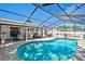 Sparkling in-ground pool within screened enclosure, complemented by ample seating and partially covered patio area at 5611 22Nd E St, Bradenton, FL 34203