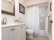 Cozy bathroom features a sink vanity and a shower behind a curtain at 5633 Sheffield Greene Cir # 40, Sarasota, FL 34235