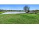 Expansive backyard features lush green lawn and a picturesque pond view, perfect for relaxation at 5954 Anise Dr, Sarasota, FL 34238