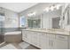 Bright bathroom with a soaking tub, separate shower, and double vanity sinks with modern fixtures and finishes at 5954 Anise Dr, Sarasota, FL 34238