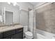 Bathroom with a modern vanity, granite countertop, shower and tub combination, and decorative towel rack at 5954 Anise Dr, Sarasota, FL 34238