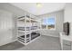 Modern bedroom featuring a unique triple bunk bed with gray linens, perfect for a shared or guest space at 5954 Anise Dr, Sarasota, FL 34238