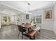 Open concept dining room features a wood table, view to the outside, and grey tile floor at 5954 Anise Dr, Sarasota, FL 34238