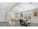 Dining room features tile floors, view to the backyard, and flows into the living room at 5954 Anise Dr, Sarasota, FL 34238