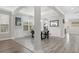 Dining room showcasing gray flooring and white wainscoting with natural light and views of the surrounding landscape at 5954 Anise Dr, Sarasota, FL 34238