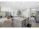 Open concept kitchen with large island and barstool seating that opens to the living room at 5954 Anise Dr, Sarasota, FL 34238